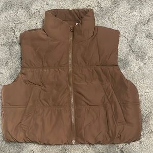 Brown, puffy, sleeveless, partial turtle neck, zip up, puff vest.